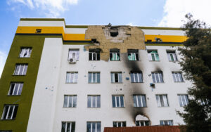 Upward view of a multistory building showing damage from an explosion